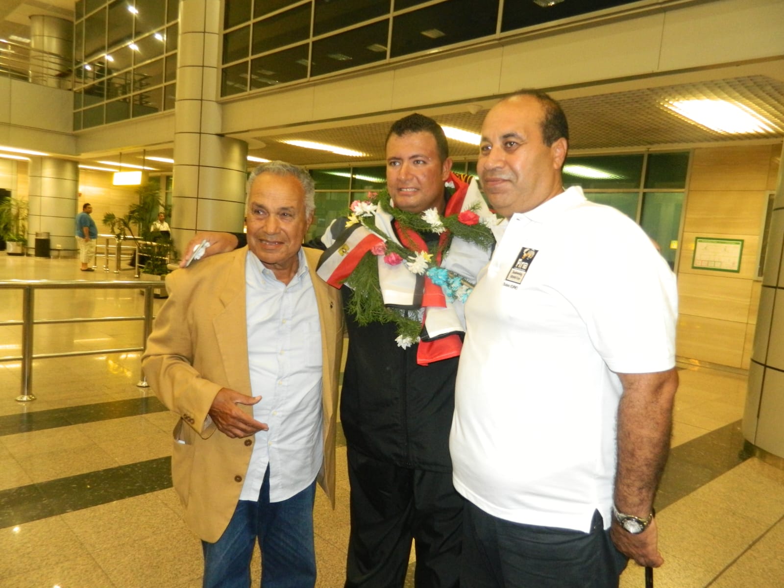 Ahmed Nasef with members of the team during an airport reception